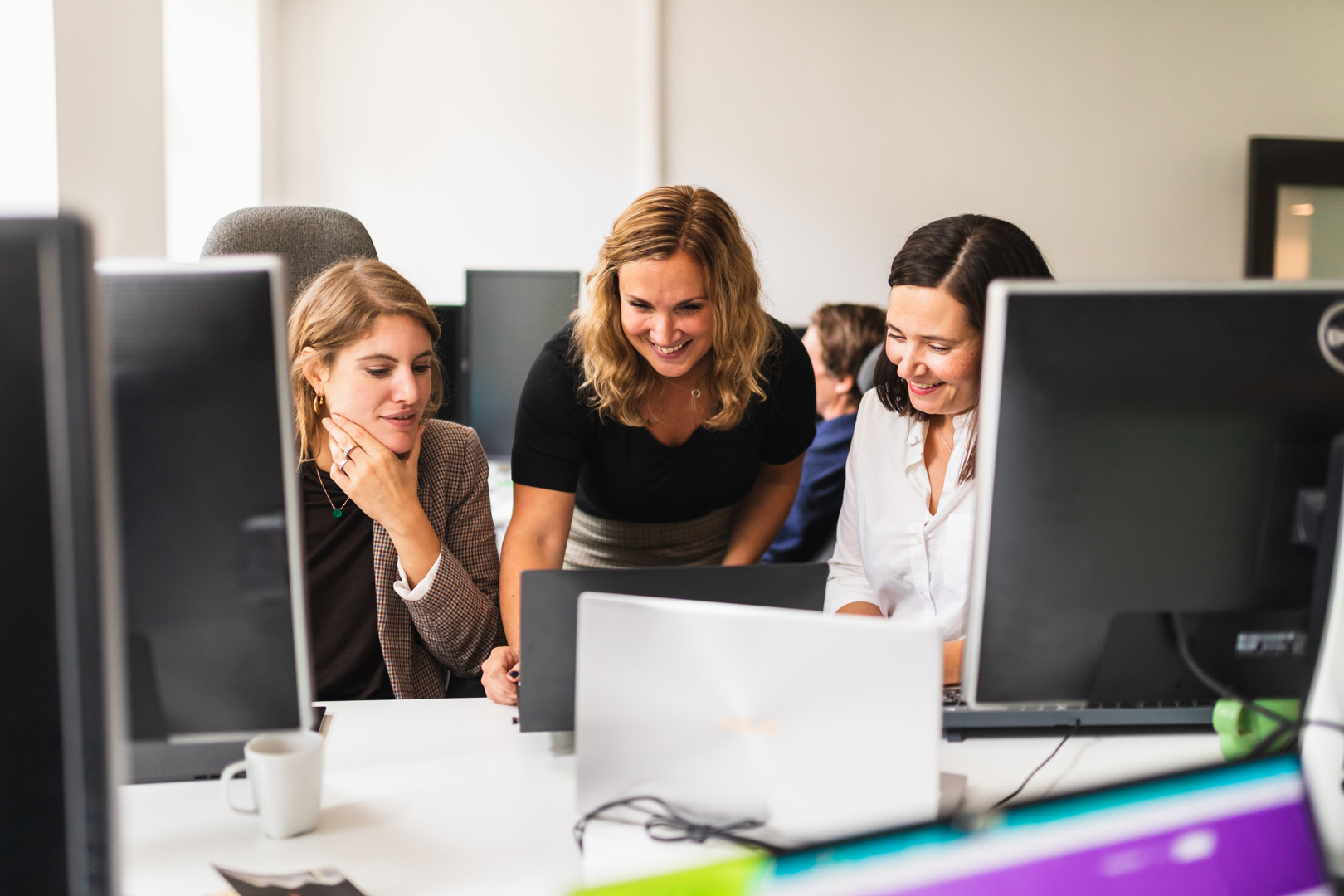 Women working together in front of computer