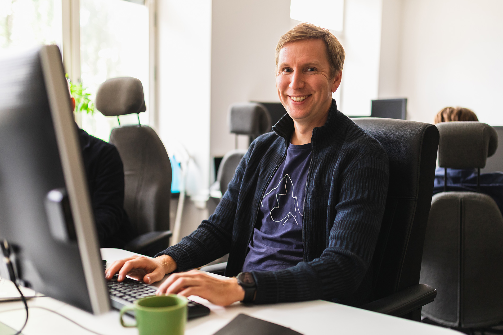 Smiling man working at a desk